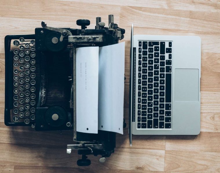gray typewriter and MacBook