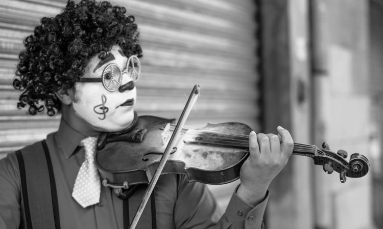 grayscale photo of man playing violin